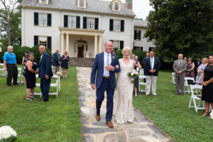 Dad and bride walking down the aisle at an outdoor wedding at Rust Manor House
